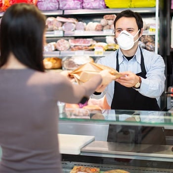 Shop worker in mask
