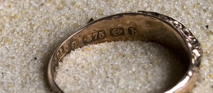 Hallmarks on a gold ring.