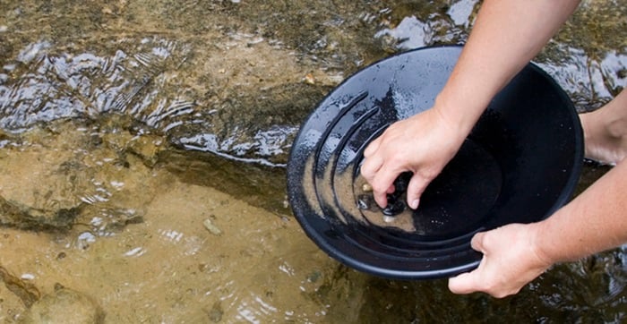 Gold panning in a river.