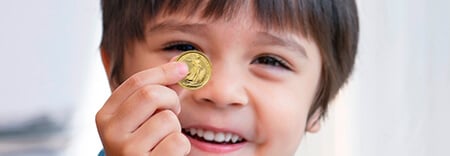 Young boy with a gold coin