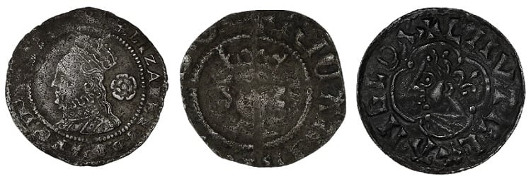 Old silver coins with a dark-toned patina.