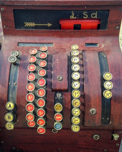 An old till showing pre-decimal currency of pounds, shillings and pence.